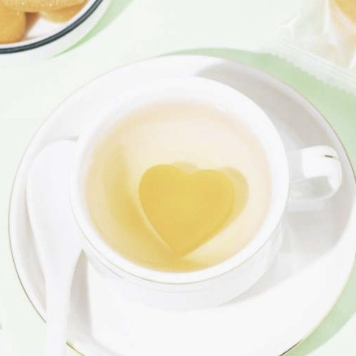 A heart-shaped honey sugar cube dissolving in a warm cup of tea. This natural sweetener adds a touch of honey and sugar to your favorite drinks, including coffee, cocktails, and champagne. Just add hot water to soften and stir for a delightful, smooth sweetness.