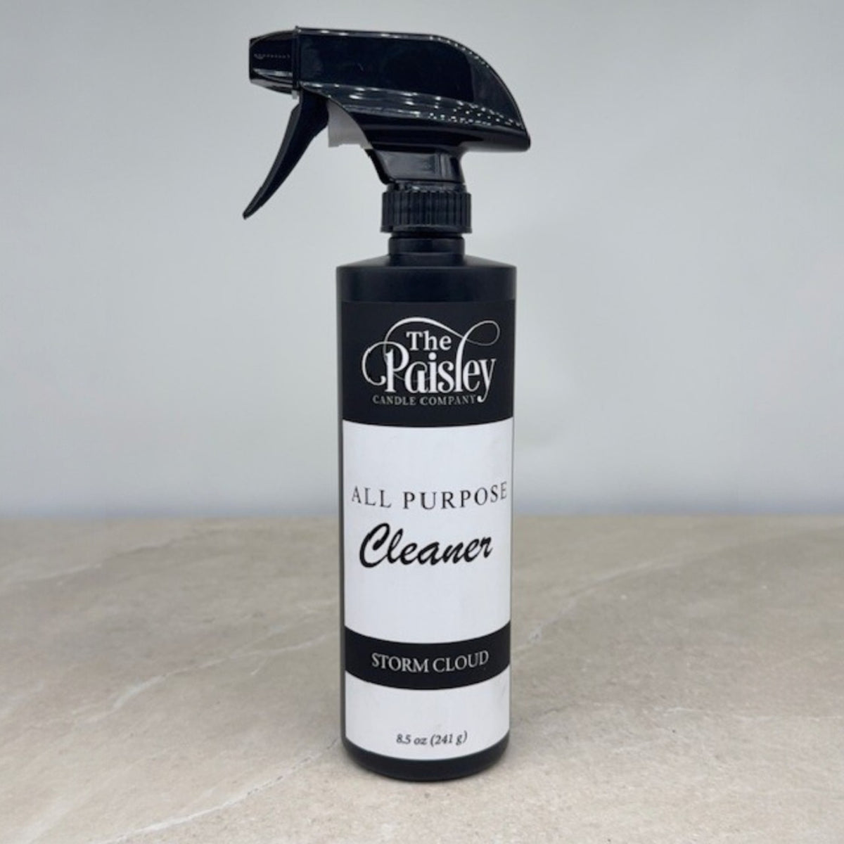 Storm Cloud all purpose cleaner by Paisley Candle Company in black spray bottle on neutral background