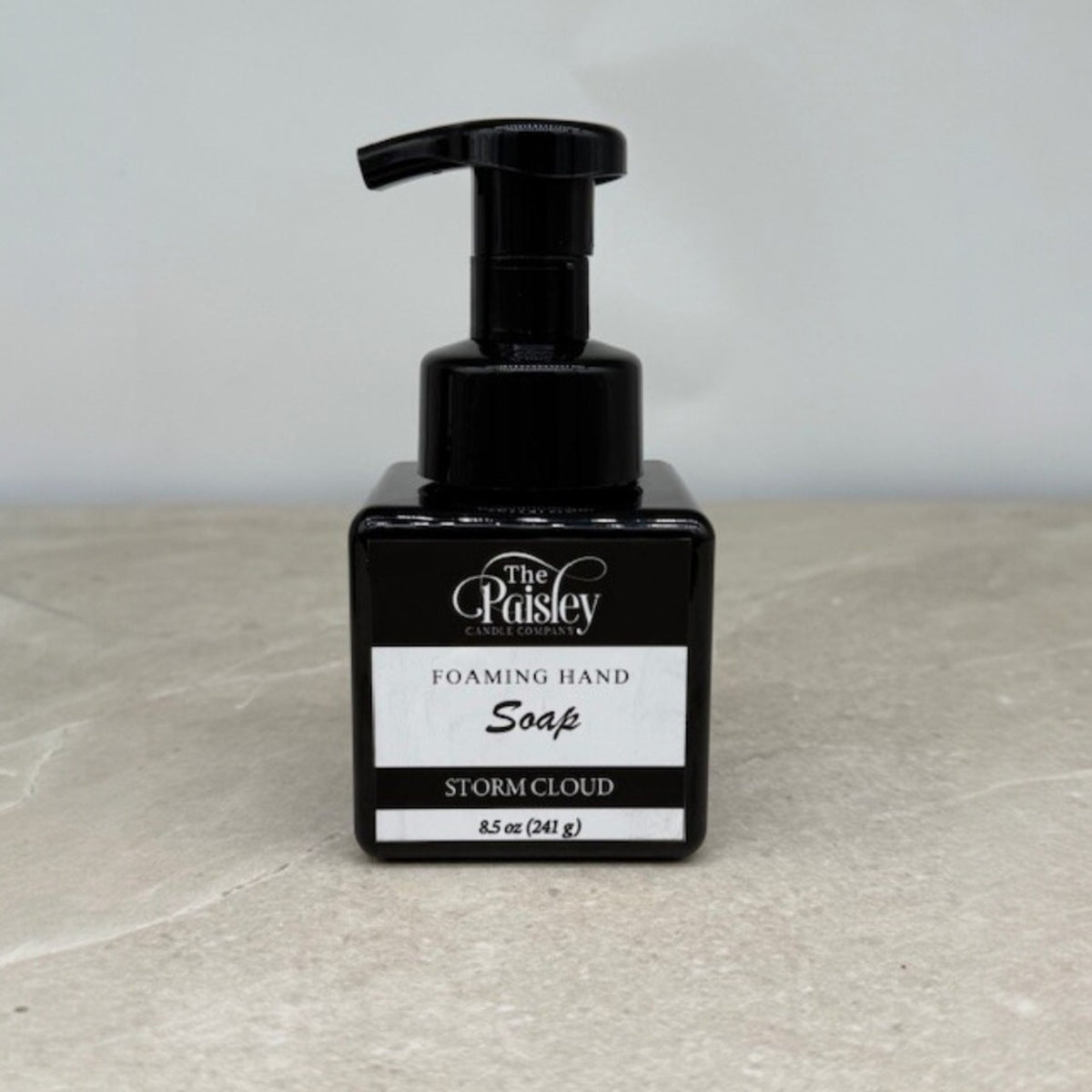 Storm Cloud foaming hand soap by Paisley Candle Company in black bottle on neutral background